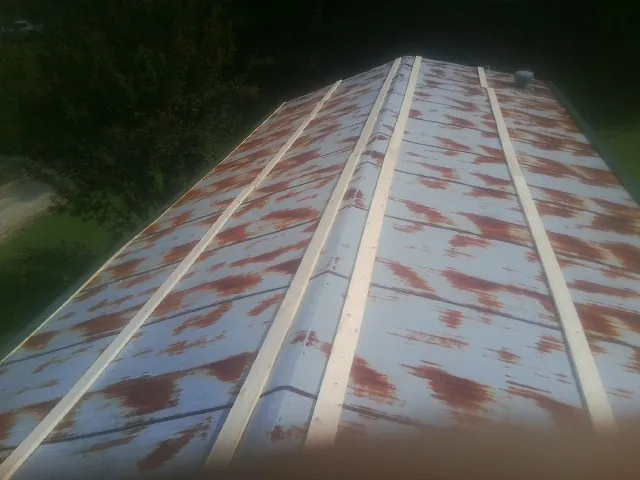 Rusted metal roof panels with new wood purlins before replacement — Storm Damage Roof Repair in Ross by Roofing Brothers