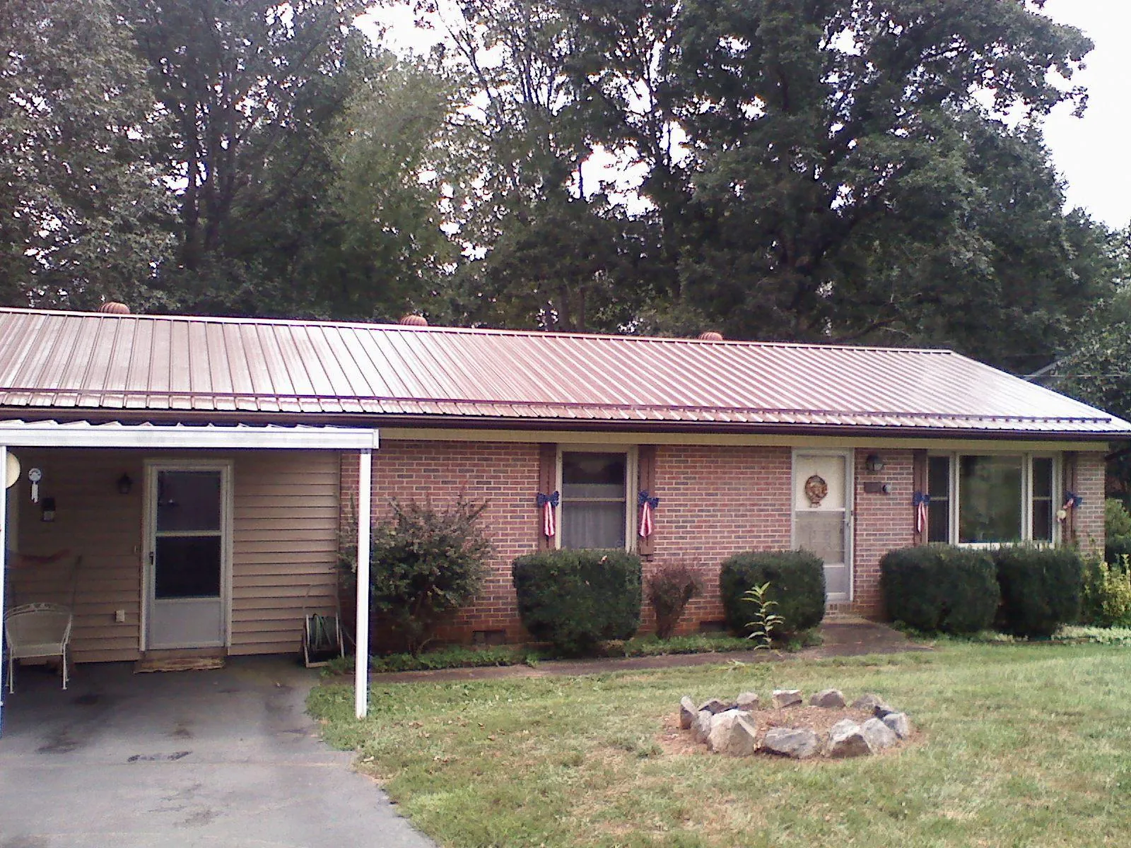 Bronze metal roof and carport on a brick ranch home — Roof Repair work by our crew in Ross